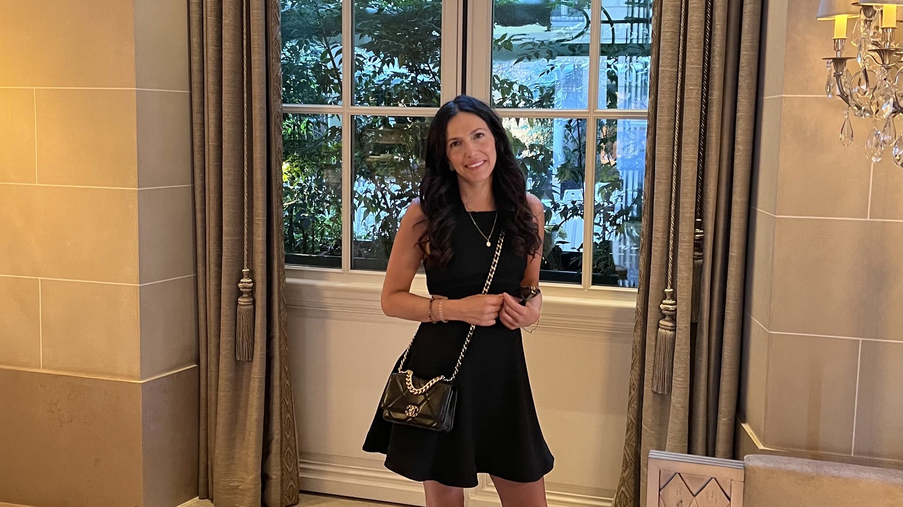 Jessica L. Rutter, founder of The Modern AI Club, in a black dress in an elegant hotel salon